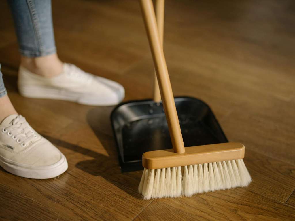 Photo by cottonbro studio Person Wearing White Pants and White Socks Standing Beside Brown Broom